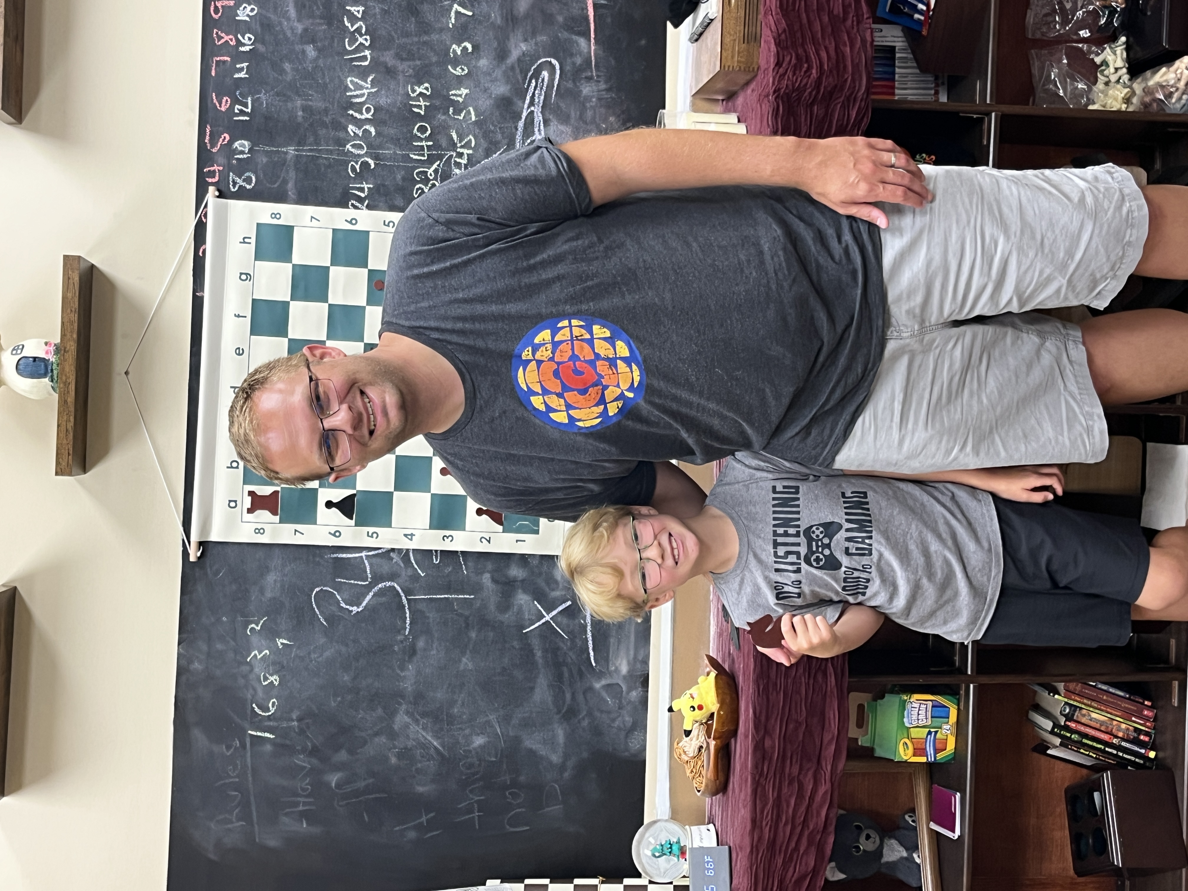A young student focused on a chess game