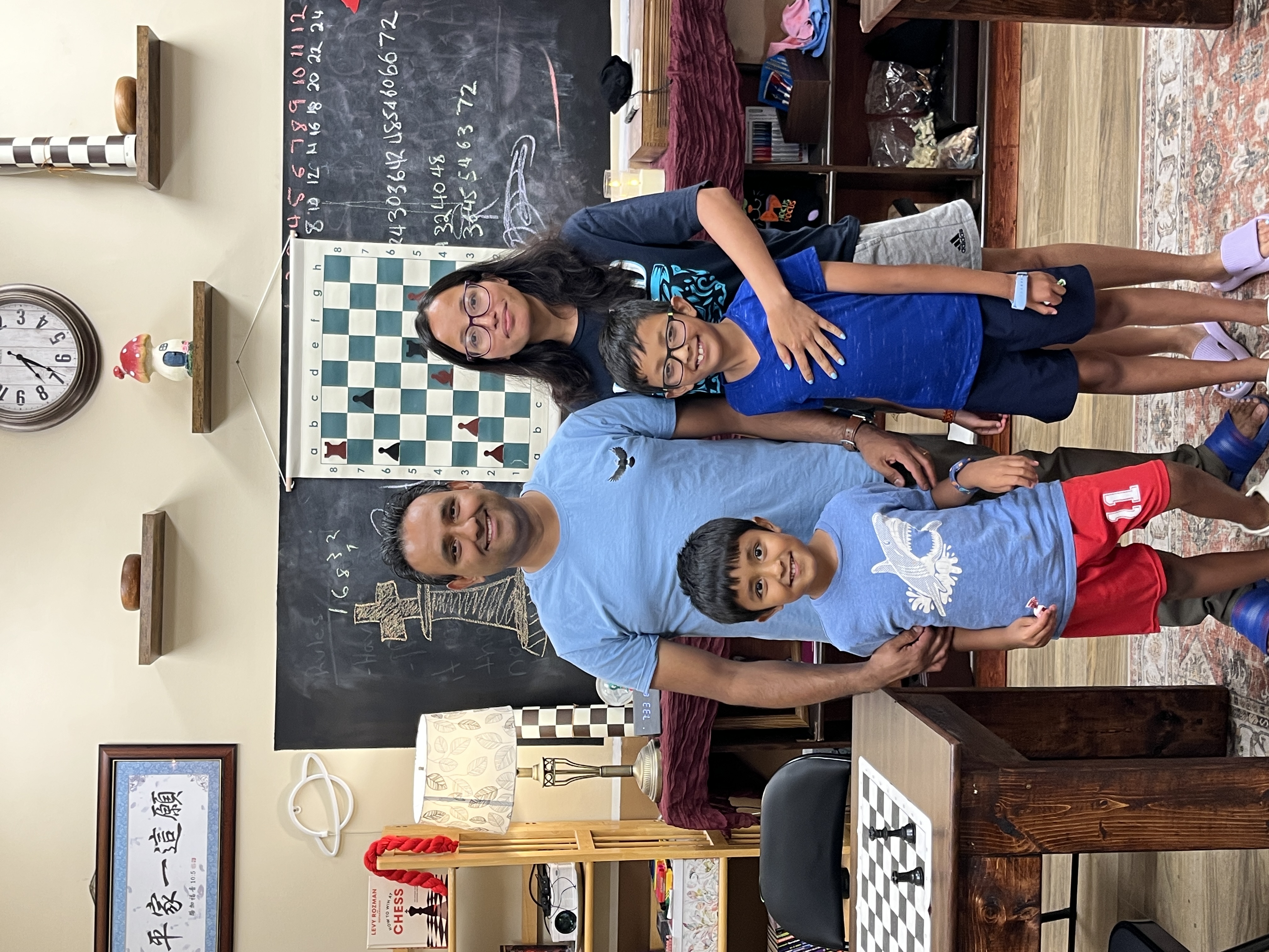 Two students shaking hands over a chessboard